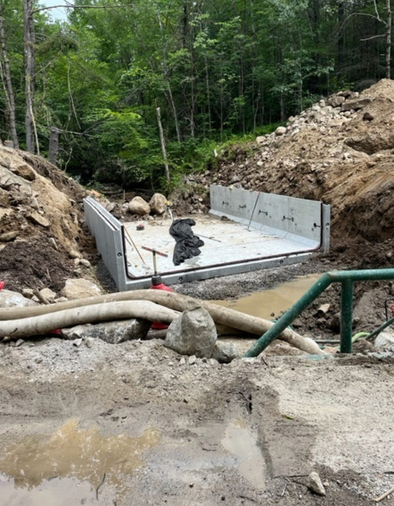 Bottom pre-cast section of box culvert being installed